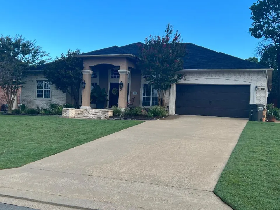 Home with a new roof and a long driveway